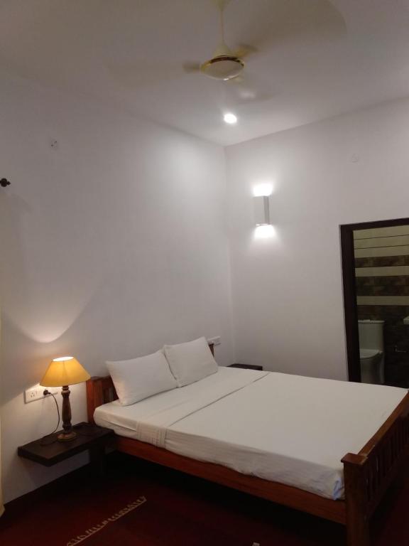 Postel nebo postele na pokoji v ubytování Marari Umapathi Beach Villa