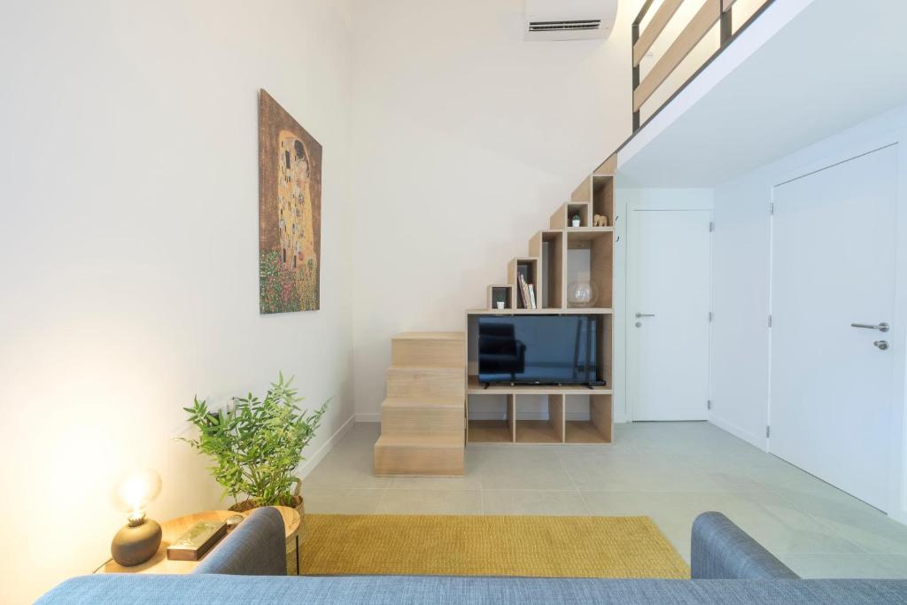 a living room with a couch and a tv at Studios with city view in Brussels