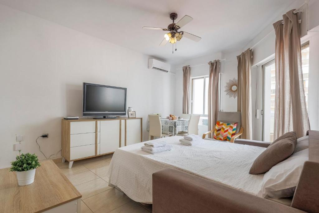 Televízia a/alebo spoločenská miestnosť v ubytovaní Un respiro en cádiz playa victoria 1 hab y salón con sofa cama
