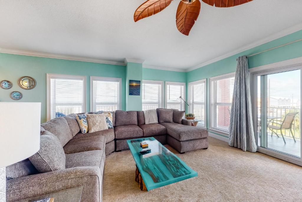 a living room with a couch and a table at Paradise Shores 200 in Mexico Beach