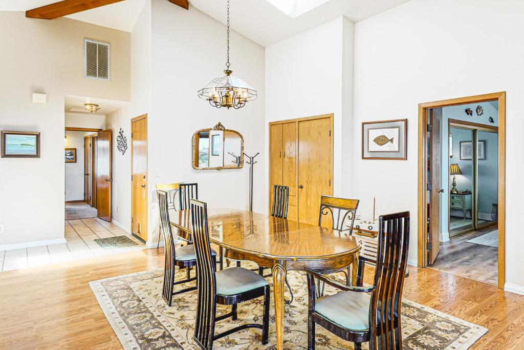 a dining room with a wooden table and chairs at Pinnacle Heights in Bodega Bay