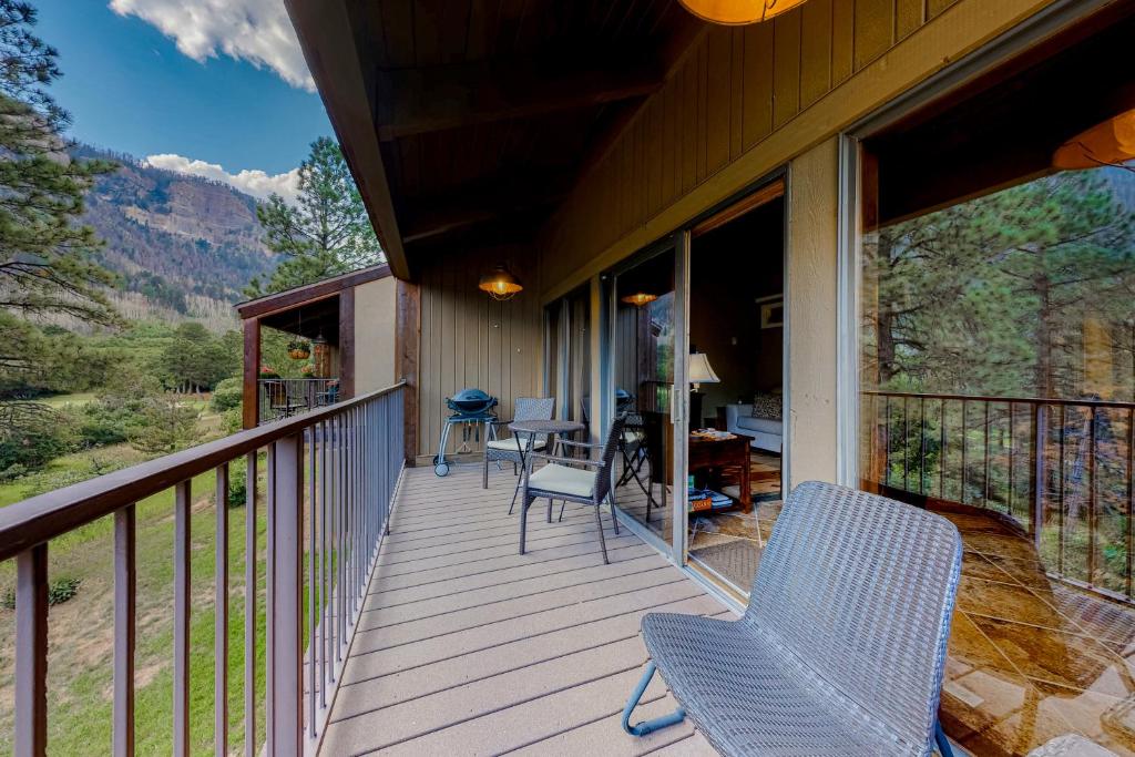 a porch with chairs and tables on a house at Durango Tango & Suite Studio in Durango