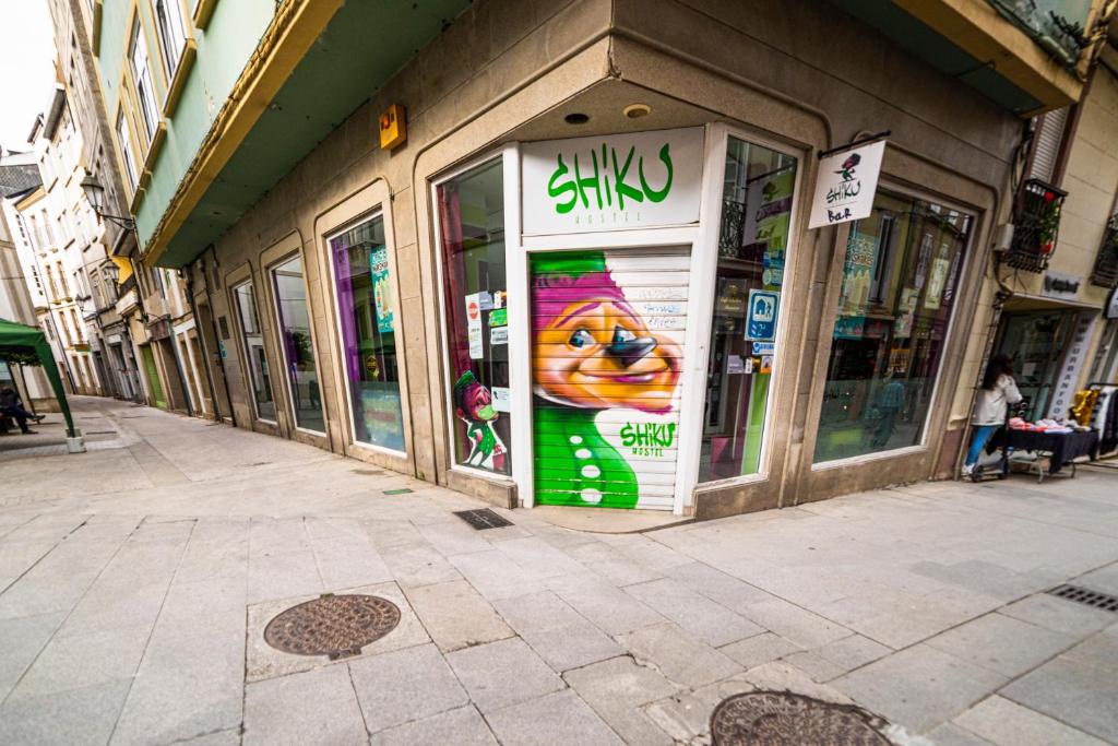 a store with a sign on the front of it at Shiku in Lugo