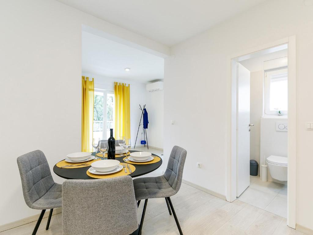 a dining room with a table and chairs at Apartment Aria in Poreč