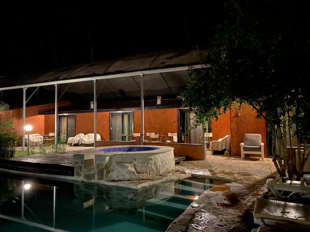 una casa con piscina por la noche en Olympos Five Rooms Apart no 3, en Yazır