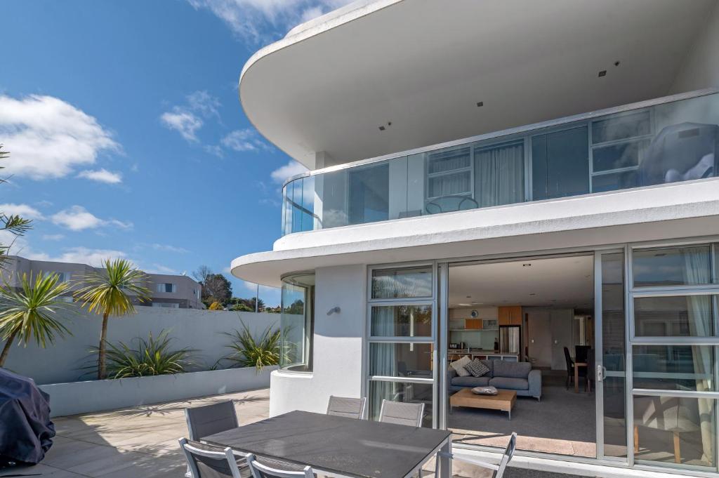 a house with a patio with a table and chairs at Waimahana 5 - Taupō Holiday Apartment in Taupo