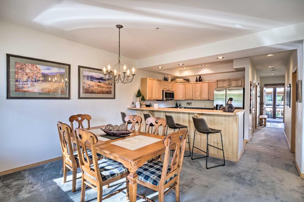 a kitchen and dining room with a wooden table and chairs at Breckenridge Condo with Hot Tub Less Than 1 Mi to Ski Lifts in Breckenridge