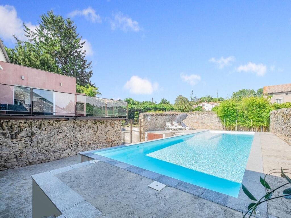 a swimming pool in the backyard of a house at Comfy Holiday Home in Saint-Denis with Private Pool in Saint-Denis