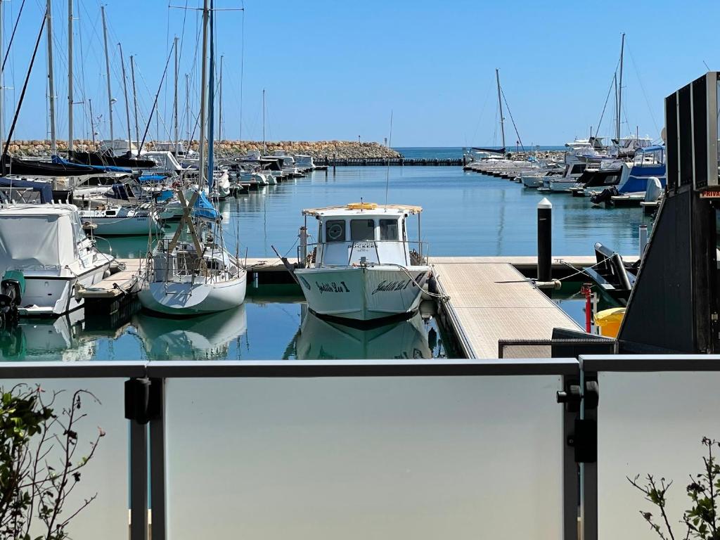 a group of boats docked in a marina at Mariner's Cove ~ Luxe Waterfront Apartment in Mindarie