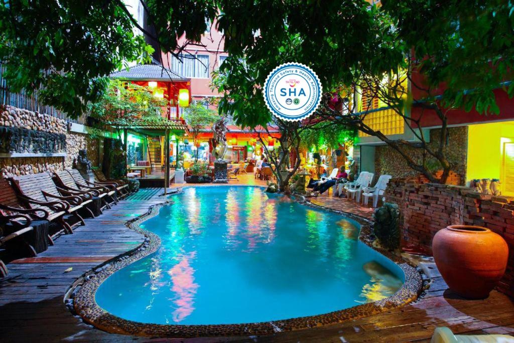 a large swimming pool in front of a building at Villa Cha-Cha Banglumphu in Bangkok