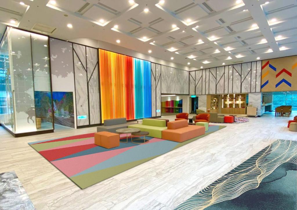a lobby with colorful furniture and large windows at Uni-Resort Ku-Kuan in Heping