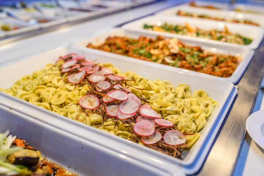 four plastic trays of food on a table at River Rock Hotel in Ayia Napa
