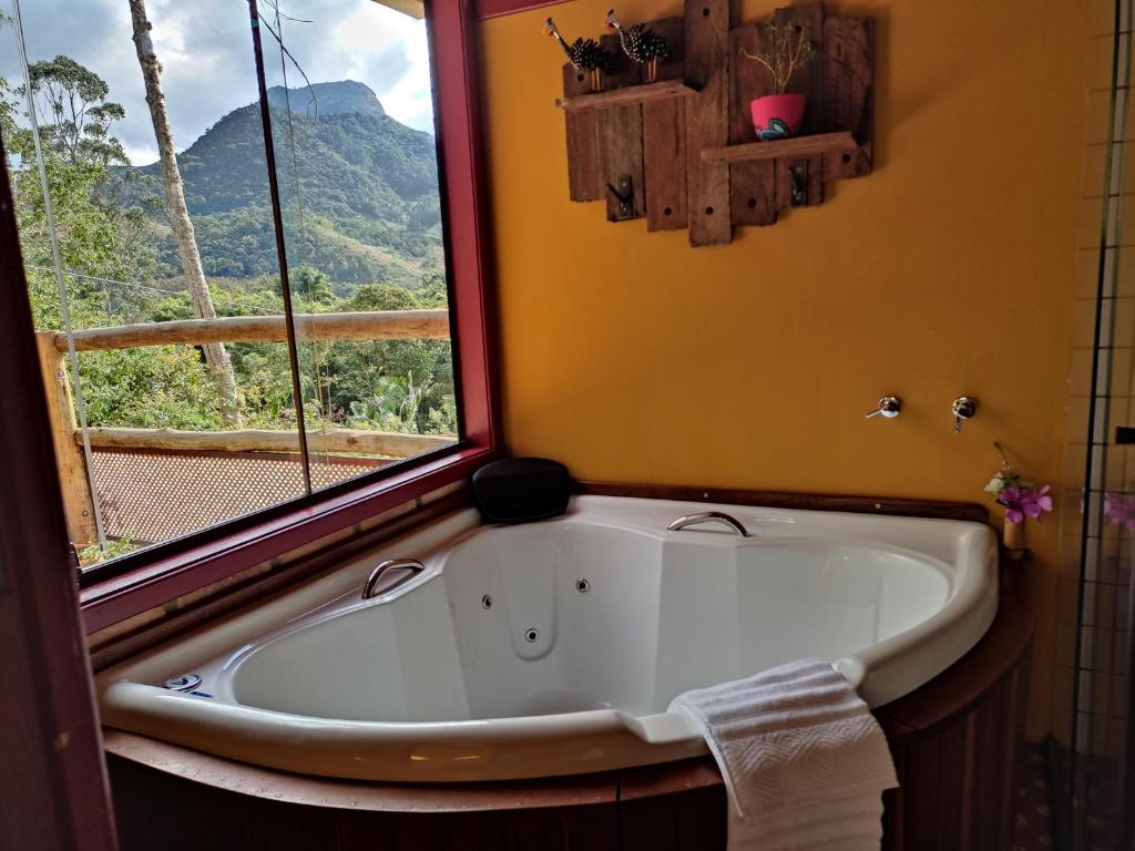 a bath tub in a bathroom with a window at Canto da Colina Lumiar in Lumiar