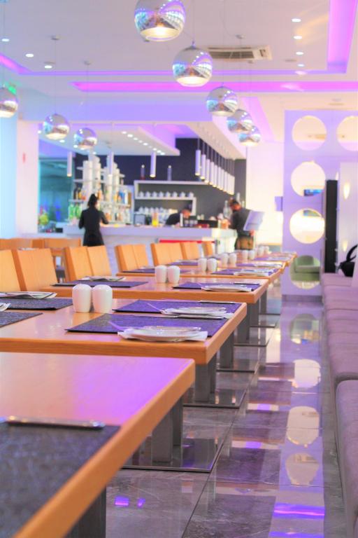 a row of tables and chairs in a restaurant at River Rock Hotel in Ayia Napa