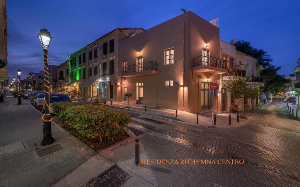 a city street at night with buildings and a street light at Residenza Rithymna Centro with a private roof terrace and hot tub in Rethymno