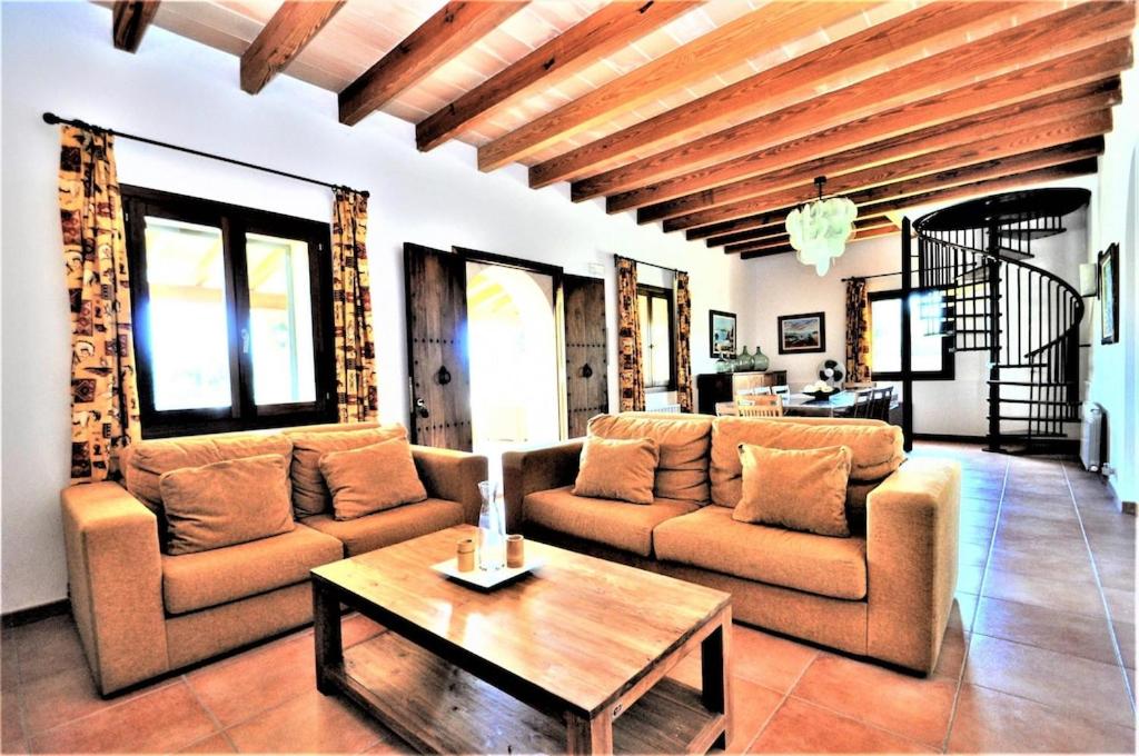 a living room with two couches and a coffee table at CAS BORRASSOS- Finca con piscina privada y Vistas Despejadas in Palma de Mallorca