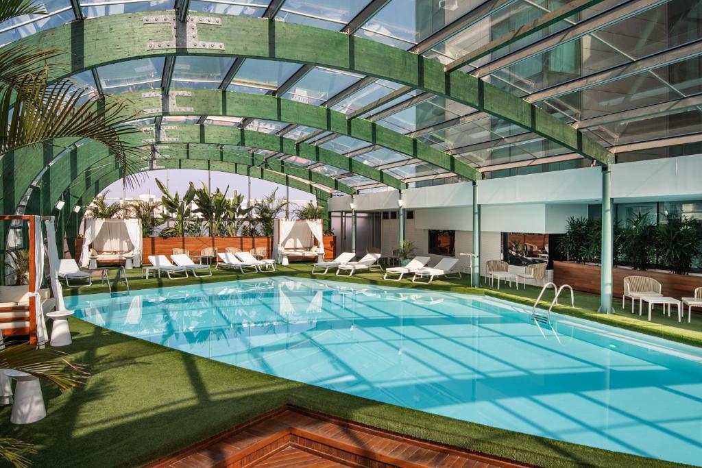 a pool in a hotel with a glass ceiling at Arrecife Gran Hotel & Spa in Arrecife