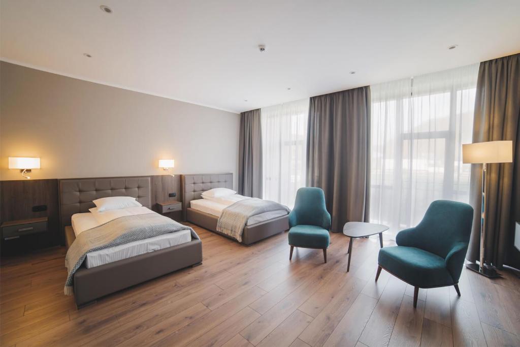 Postel nebo postele na pokoji v ubytování Hotel Irys by Derenivska Kupil