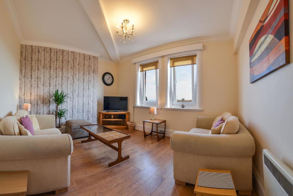 a living room with two couches and a tv at The Whitby Prospect in Whitby