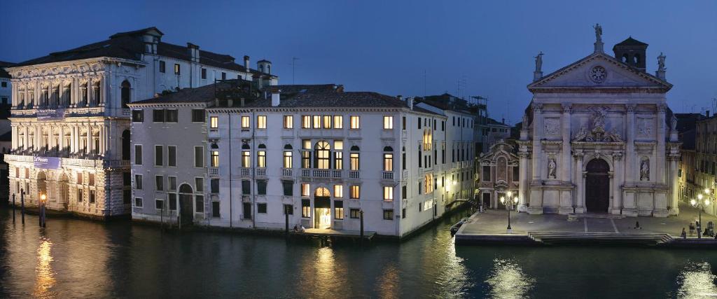 a group of buildings on the water at night at Hotel Palazzo Giovanelli e Gran Canal in Venice