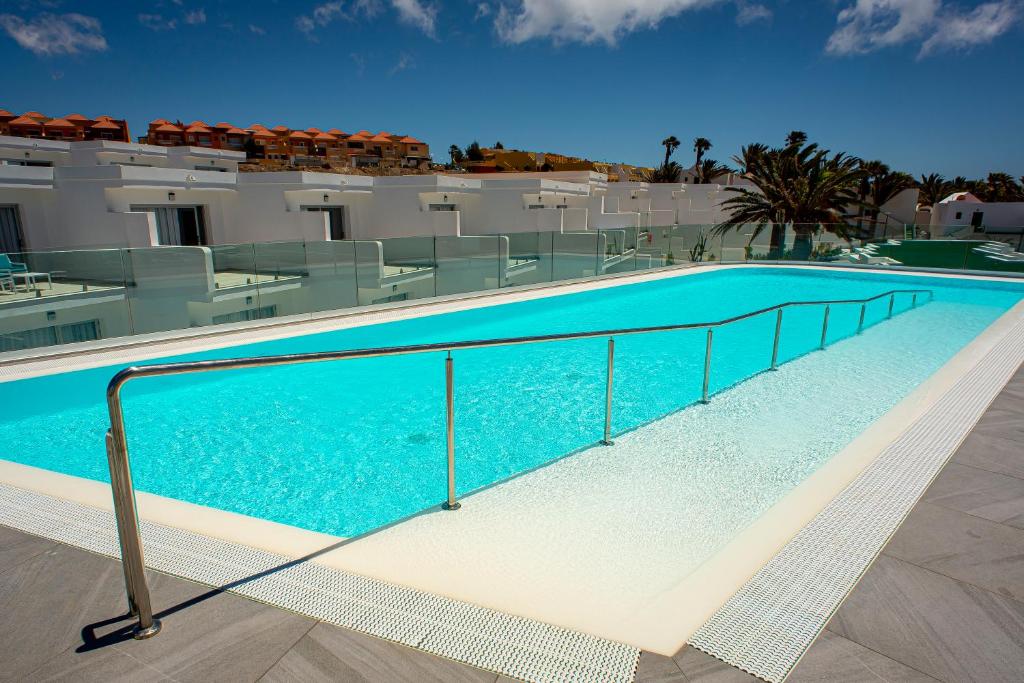 a swimming pool in front of a building at Hotel Taimar in Costa Calma