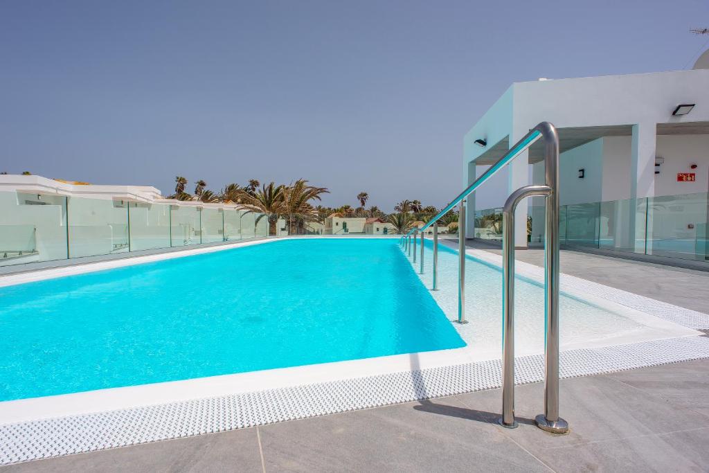 a swimming pool on the side of a building at Hotel Taimar in Costa Calma