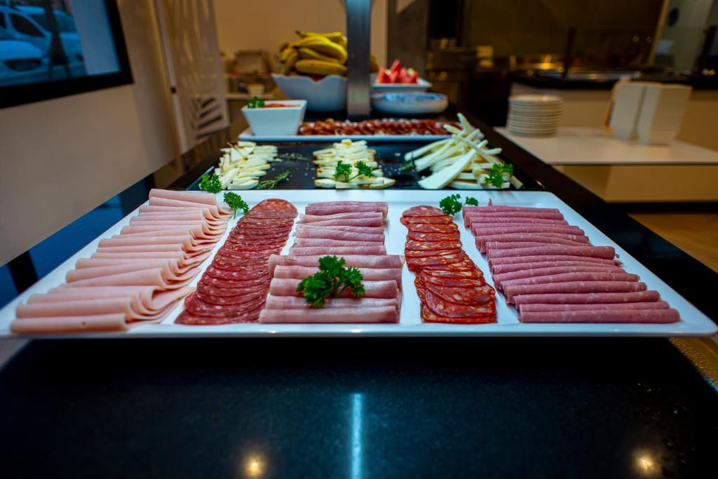 a buffet of different types of meats on a table at Hotel Taimar in Costa Calma