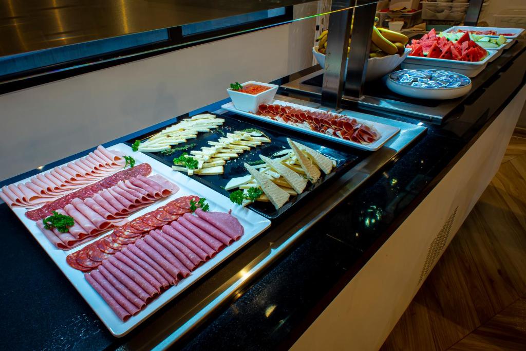a buffet line with different types of meats and appetizers at Hotel Taimar in Costa Calma