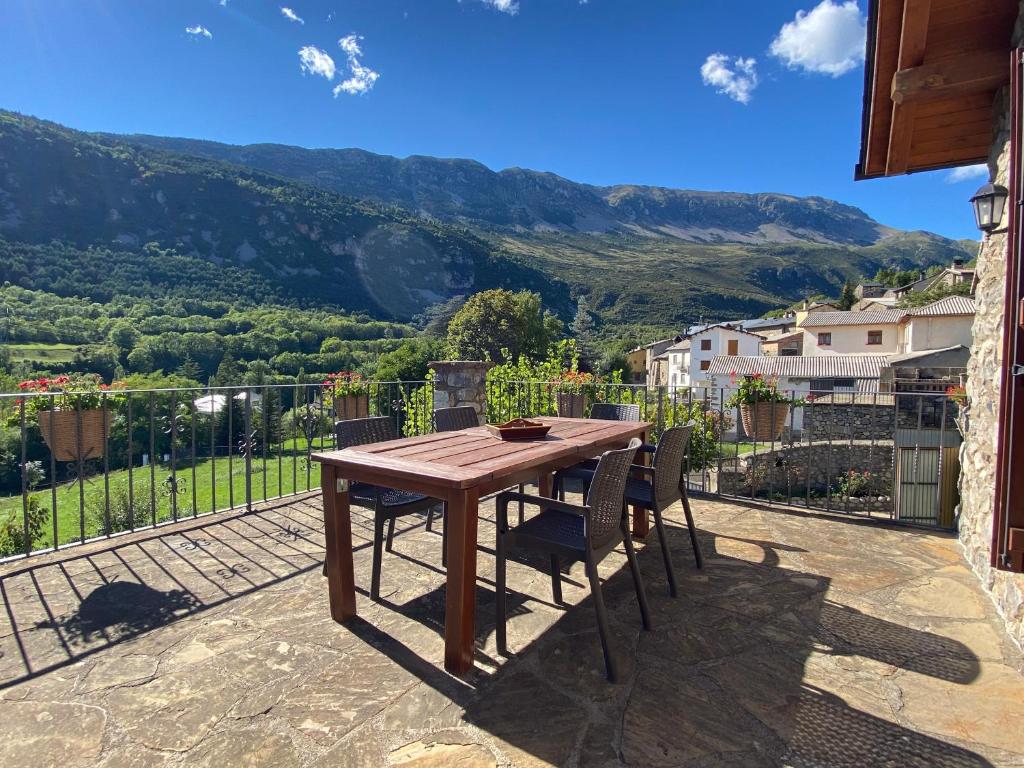 a wooden table and chairs on a patio with a view at Casa Sansón in Chía