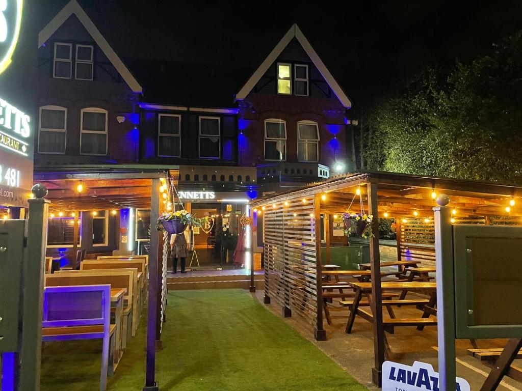 ein Restaurant mit Lichtern vor einem Gebäude in der Unterkunft Bennetts Hotel in Long Eaton