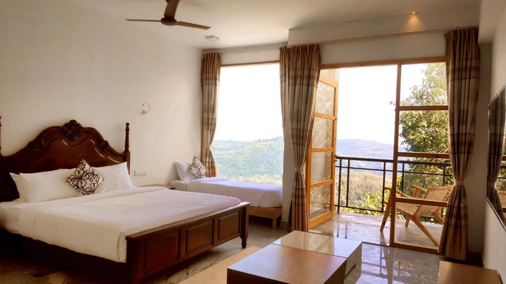 a bedroom with a bed and a large window at MERIDIAN HILL TOP YERCAUD in Yercaud