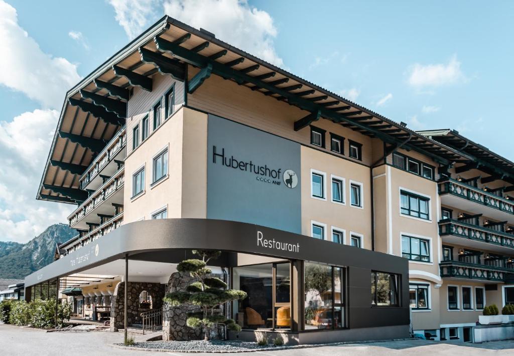 a hotel in the mountains with a building at Hotel Hubertushof in Anif