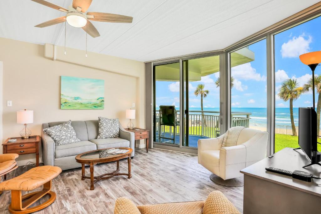 a living room with a view of the ocean at Blue Umbrella in Daytona Beach Shores