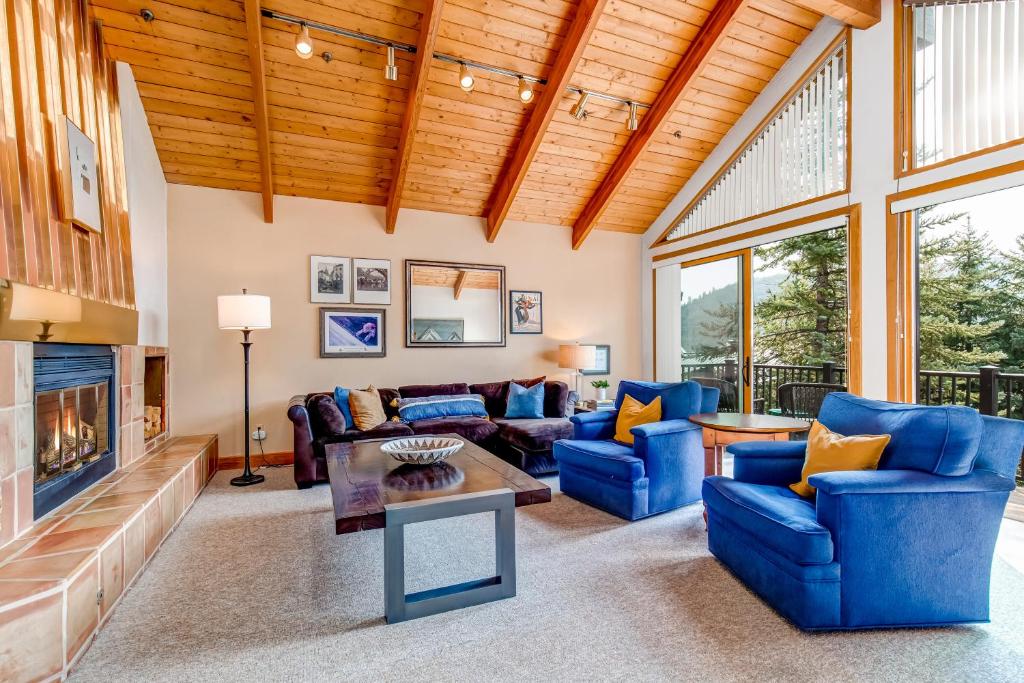 a living room with blue couches and a fireplace at Pinnacle Peak in Park City