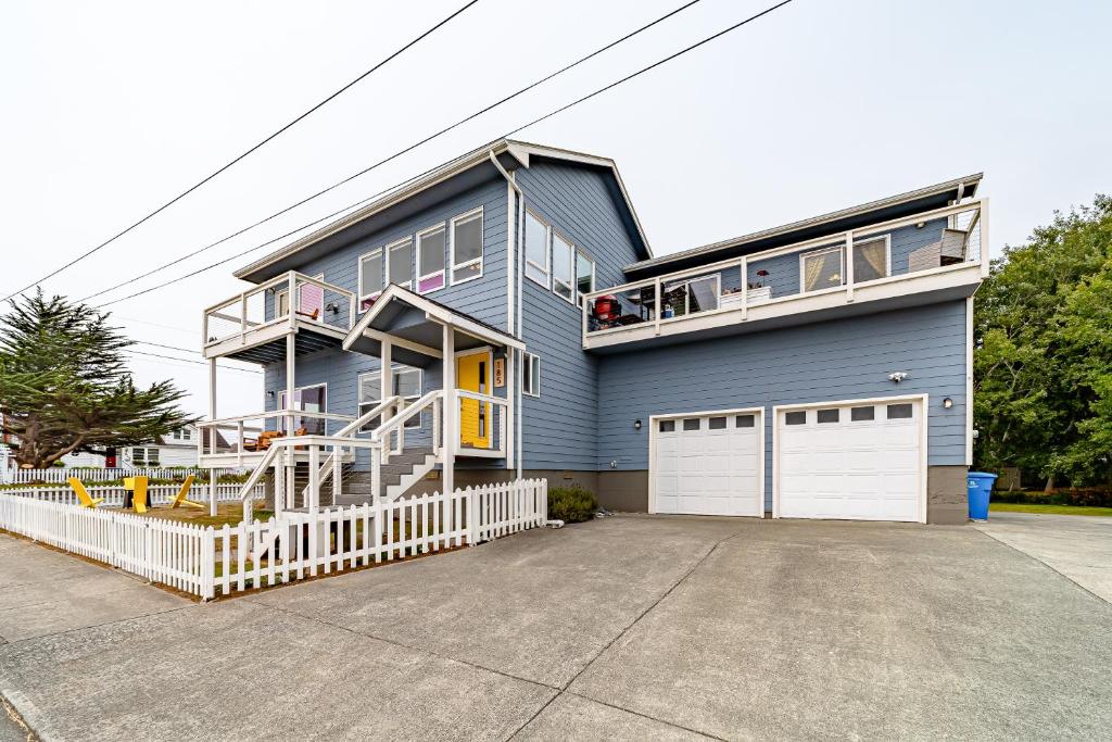 a blue house with a porch and a balcony at This Is It in Crescent City