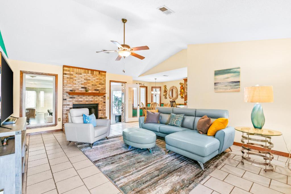 a living room with a blue couch and chairs at Pleasant Palms in Navarre