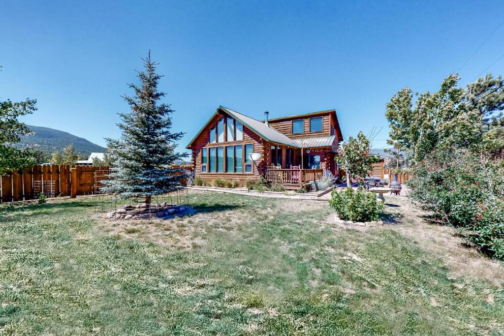 a large wooden house with a tree in the yard at The Norma Charles in South Fork