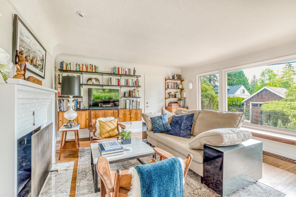 a living room with a couch and a fireplace at Lake Oswego Mid-Century in Lake Oswego