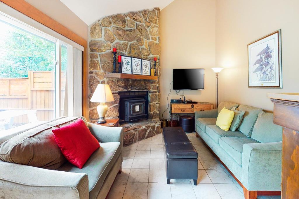 a living room with a couch and a fireplace at Mountain Dreams Condo in Fraser