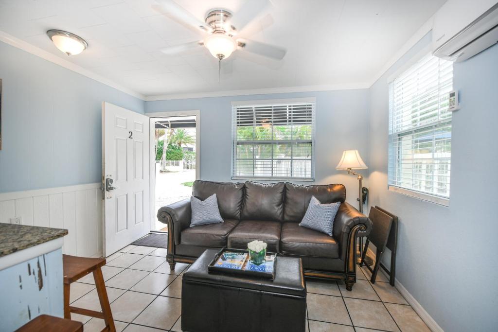uma sala de estar com um sofá e uma mesa em Parrot Beach Cottages Suite #2 em Siesta Key