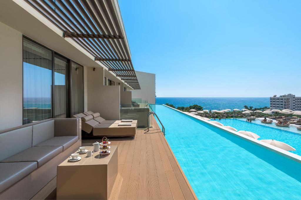 a living room with a swimming pool on a building at Amarande (Adults Only) in Ayia Napa