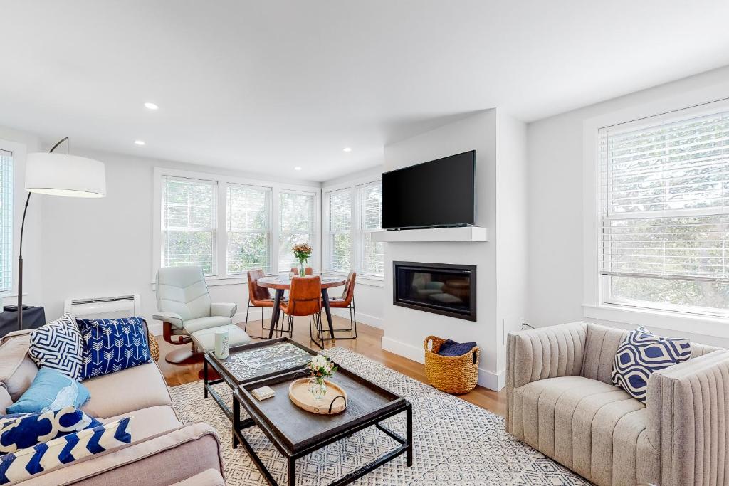 a living room with a couch and a table at Ptown Treehouse in Provincetown