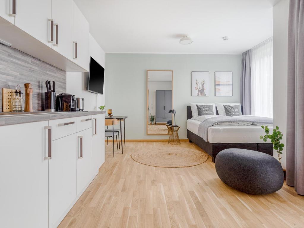 a bedroom with a bed and a kitchen with a table at limehome Dresden Wallstraße - Digital Access in Dresden