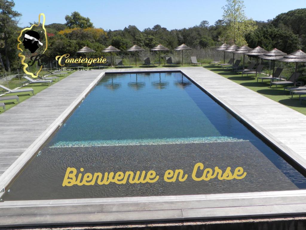 a swimming pool at a resort with a sign that says blueuce an course at Résidence Cala Sultana N°83 T3 Rez de Jardin 4/6 pers - 50m Plage Santa Giulia in Porto-Vecchio