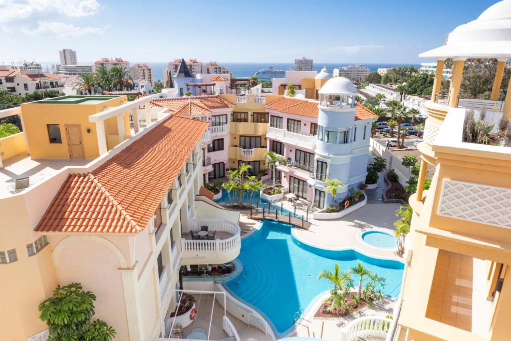 an aerial view of a building with a swimming pool at Atlas Suites Tenerife by EnjoyaHome in Los Cristianos