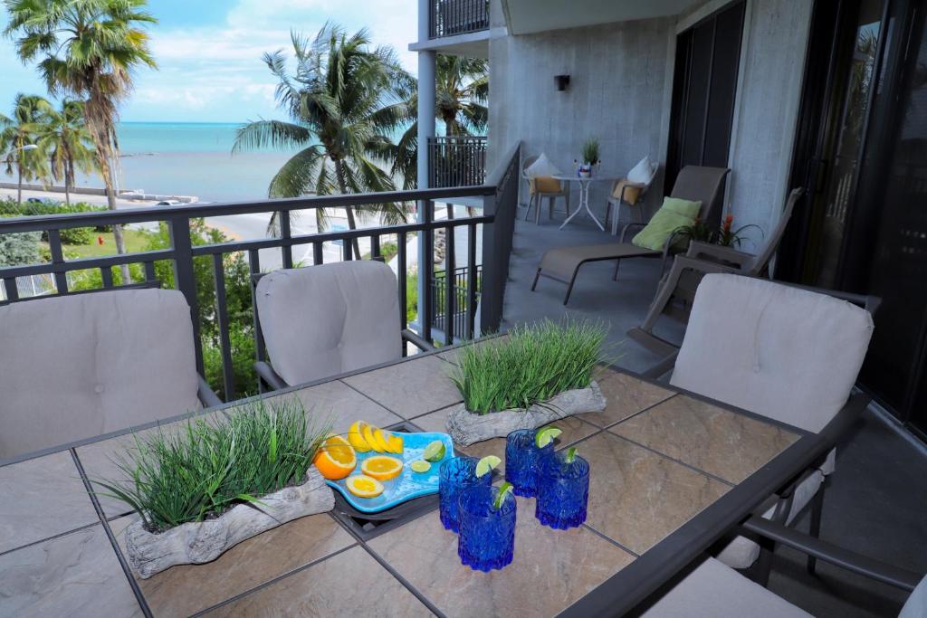 a table on a balcony with a view of the ocean at Hemingways Atlantic Retreat in Key West
