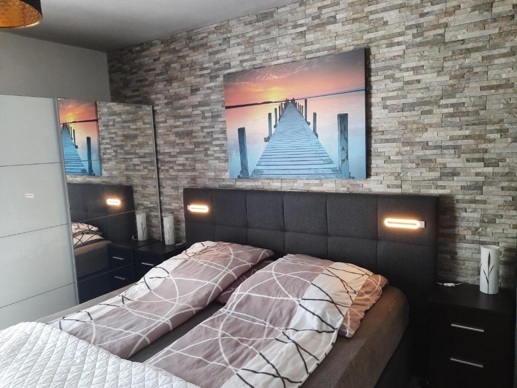 a bedroom with a bed with a picture on the wall at Joys Ferienwohnung in Oberhausen