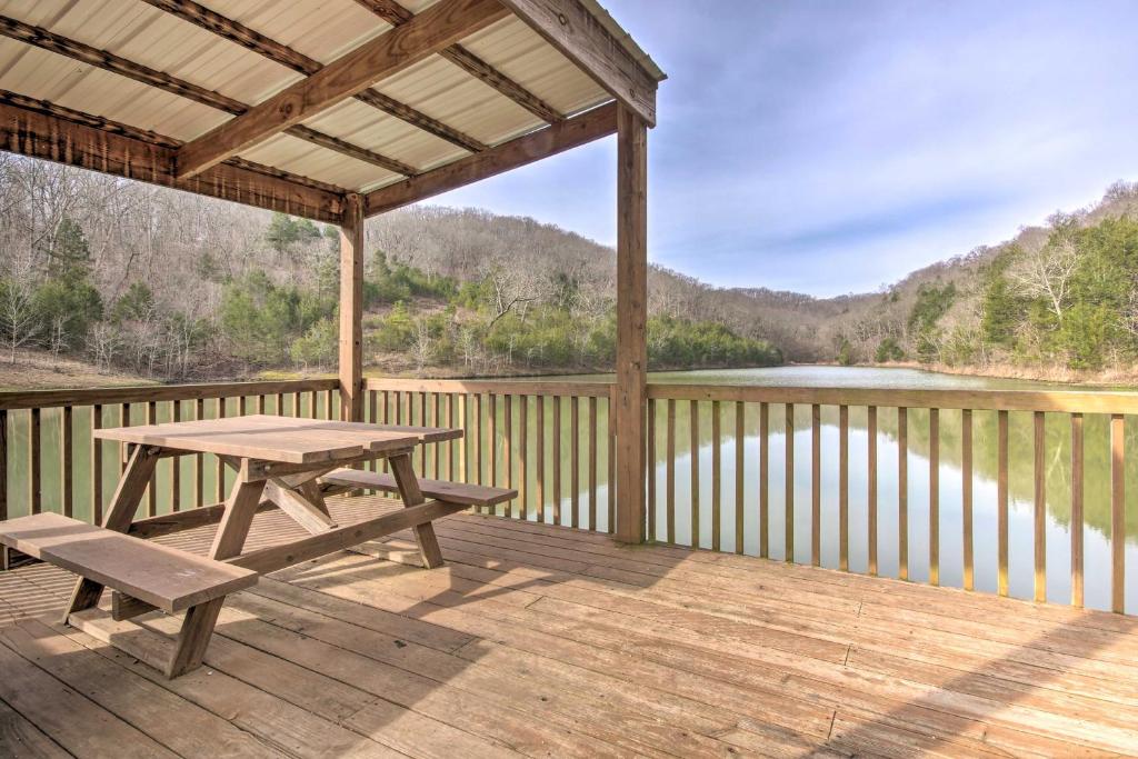 a picnic table on a deck with a view of a lake at Branson West Condo Balcony, Central Location in Branson West