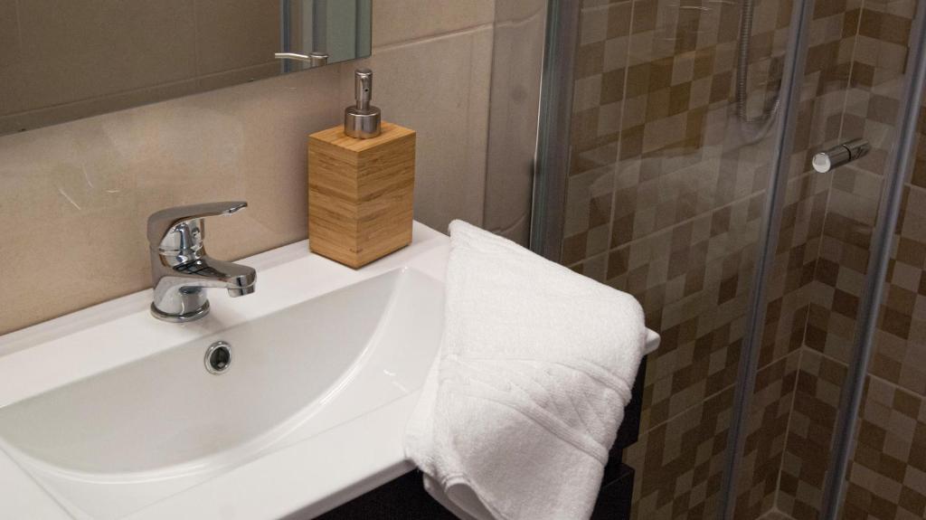 a bathroom with a sink and a shower at Breathe In in Zambujeira do Mar