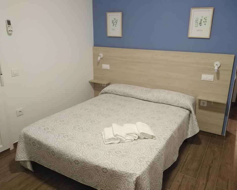 a bedroom with a bed with two white towels on it at LA VILLA DE ORGAZ in Orgaz